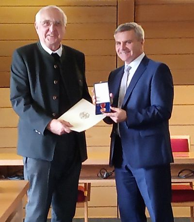 Landrat Peter Dreier überreicht Monsignore Johann Schober das Verdienstzeichen der Bundesrepublik Deutschland, verliehen vom Bundespräsidenten Frank-Walter Steinmeier